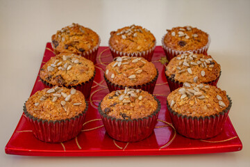 
Christmas muffins with sunflower seed decoration on red square tray