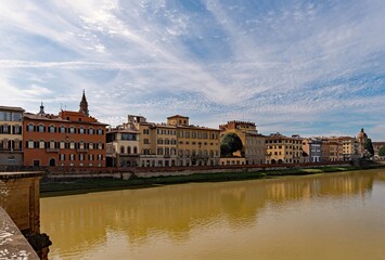 Fototapeta na wymiar Row of houses reflecting in the Arno River at the old town of Florence, Tuscany Region in Italy 