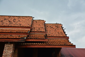 The gable roof uses clay tile materials.
