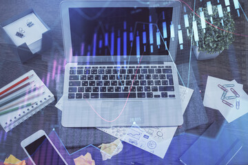 Financial graph colorful drawing and table with computer on background. Multi exposure. Concept of international markets.