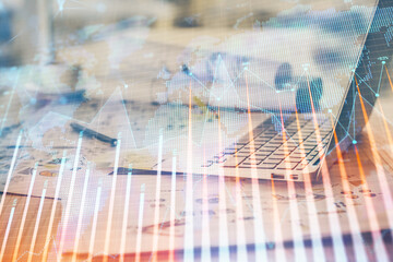 Forex market graph hologram and personal computer on background. Double exposure. Concept of investment.