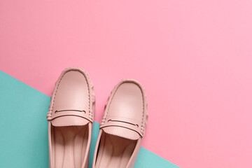 Stylish women shoes on pink and blue background. Copy space.