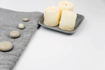 Gray zen pebble hot stones with towel on massage table in beauty salon. Hot stone massage setting. Concept set of harmony, balance and meditation, spa, relax, spa treatment