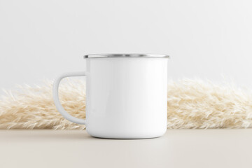 Enamel mug mockup with a pampas on a beige table.