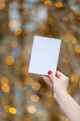 close up woman hand holding empty white card
