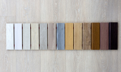 Samples of wood of different colors and species for laminate and parquet flooring. Multi-colored...
