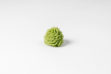 A serving of wasabi for sushi. Japanese garnish on a neutral light background