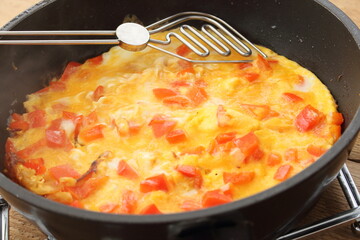 delicious omelette with paprika in a pan