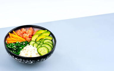 An overhead diagonal, isometric projection photo of poke bowl, traditional Hawaiian and Japanise raw fish salad, from seaweed, rice, salmon, cucumber, soy sause and avocado. with chopsticks and sesame
