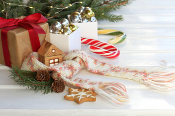 Christmas ginger star with a fir branch, pine cones and a knitted scarf on the background of...