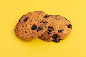 Chocolate chip cookies on yellow background. Close-up.