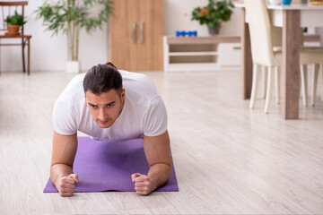 Young male starting day with morning exercises