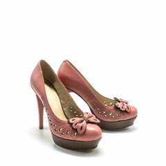 Women's shoes with high thin heels and a thick platform. Made of genuine leather in pink and brown colors. Decorated with an openwork neckline, stitching, bow. Isolated over white background.
