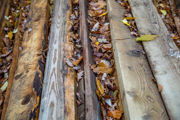 Heap of long wooden boards for the construction and improvement of the yard