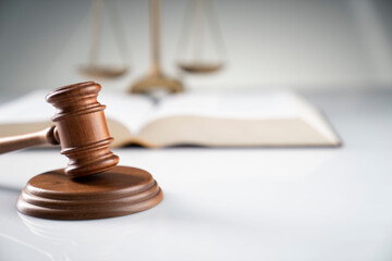 Law and justice concept. Gavel, legal code and scale on the off-white background.