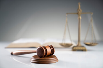 Law and justice concept. Gavel, legal code and scale on the off-white background.