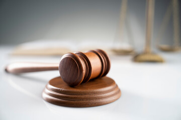Law and justice concept. Gavel, legal code and scale on the off-white background.