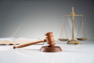 Law and justice concept. Gavel, legal code and scale on the off-white background.