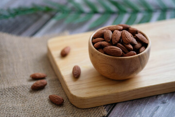 Close up almonds in the wooden bowl