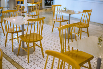 Blurred background view Of modern restaurant décor using vintage wooden chairs and tables and saving space for placement