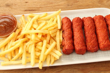delicious french fries with cevapcici rolls and dip