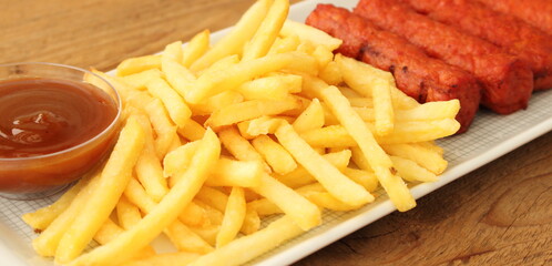 delicious french fries with cevapcici rolls and dip