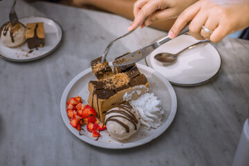 Blurred background view Of the dessert menu (Honey Toast) that contains ice cream, whipped cream, sour fruit like strawberries to be decorated and served to the customer.