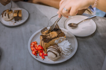 Blurred background view Of the dessert menu (Honey Toast) that contains ice cream, whipped cream, sour fruit like strawberries to be decorated and served to the customer.
