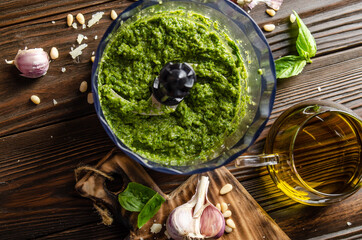 Flat lay view at italian national traditional genovese pesto sauce in food processor bowl