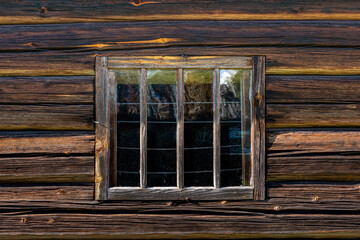 Very old window in an old weathered log cabin in Sweden