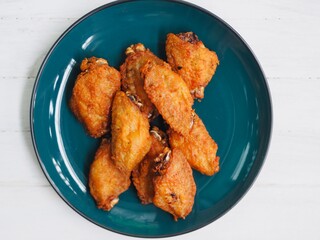 Crispy Drumsticks chicken wing fried on tissue paper absorbed oil