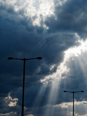 I parked my car in the parking lot of the airport and watched the outdoor lights and the sun shine through the clouds.
