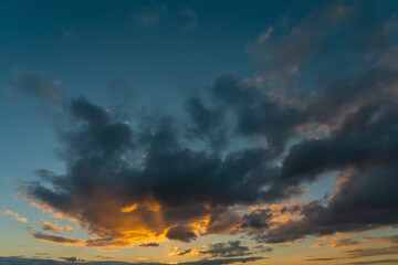 Obraz premium Dramatic sunset sky, orange and dark clouds.