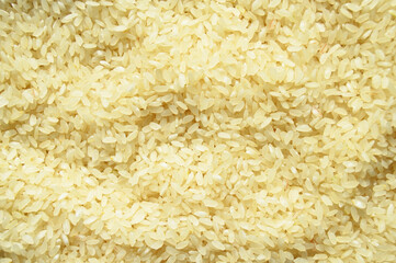 Fresh organic white raw rice grains texture, uncooked rice background