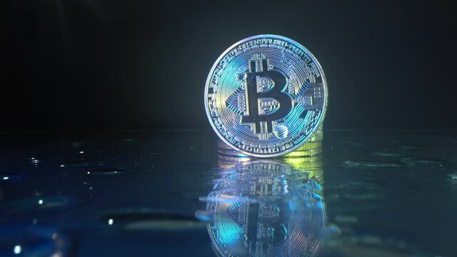 Bitcoin. Crypto currency Gold Bitcoin, BTC, Bit Coin. Macro shot of Bitcoin coins isolated on black background Blockchain technology, bitcoin mining concept. Blockchain digital technology. Drop on the