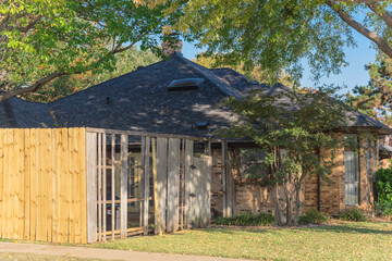 Front yard of corner house with wooden fence replacement in progress suburbs Dallas, Texas, USA