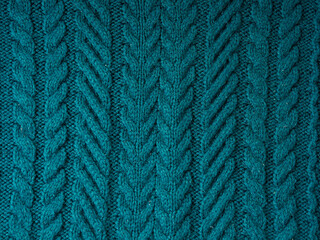 Knitted background. Knitted texture. A sample of knitting from wool. Knitting Pattern.