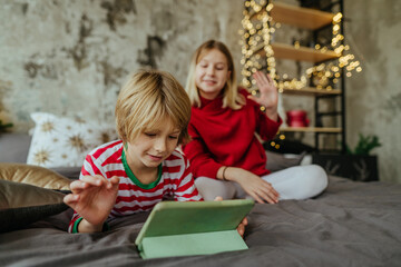 Boy and girl using tablets in Christmas time