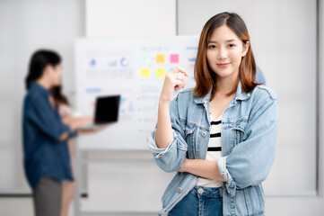 Young women asian confidence team leader business looking camera and smile in modern office room with blurred background group people