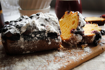 Cherry pie cut into pieces on a wooden board