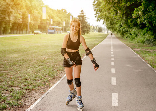 Teenage Girl In Sportswear Roller Skating