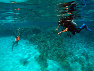 Scuba divers in the blue water. Sharm El Sheikh, Egypt 