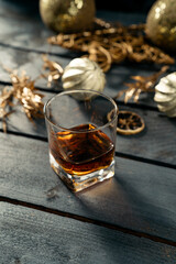 Glass of whiskey on dark blue wooden background