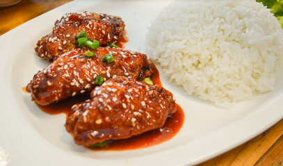 Fried Chicken with Korean Sauce and Thai rice on white plate.