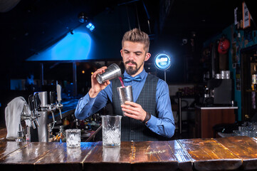 Bartender mixes a cocktail in the bar