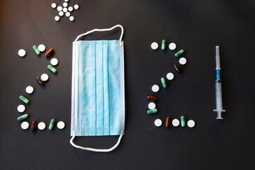Happy New Year - the number of the coming year made of pills, poppies and vaccinations