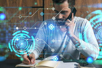 Handsome man talking phone and making notes at office workplace. Multiexposure. Tech information...