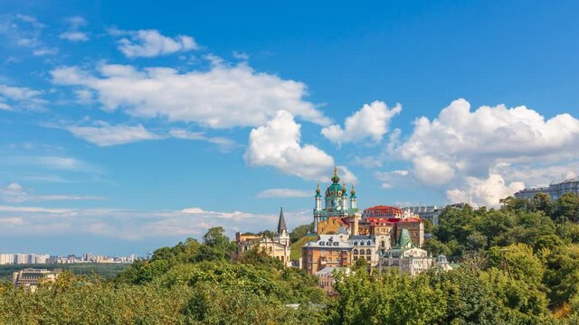Kyiv old city architecture, Famous St. Andrew’s Church and panorama of Kiev city in Ukraine. White clouds motions on blue sky, 4k time lapse