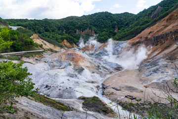 Steam coming out of the ground in the "Hell Valley", hot spring resort of Noboribetsu