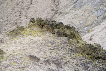 Close-up view of volcanic rock with yellow sulfur incrustations, in the "Hell Valley", hot spring resort of Noboribetsu